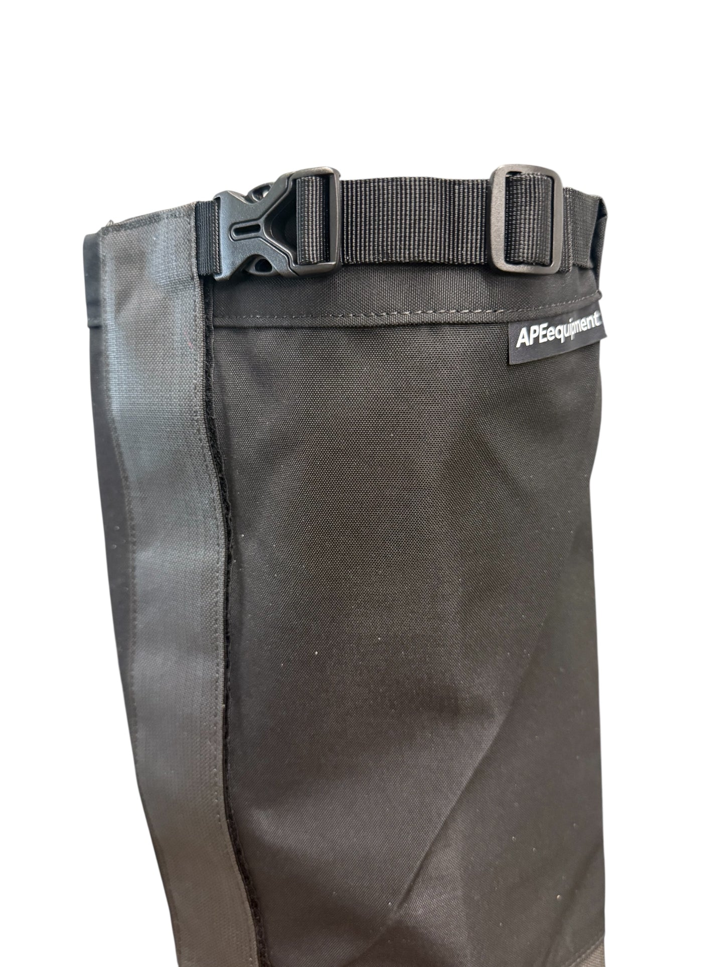 Dark gray pants with a belt and visible brand logo on a white background